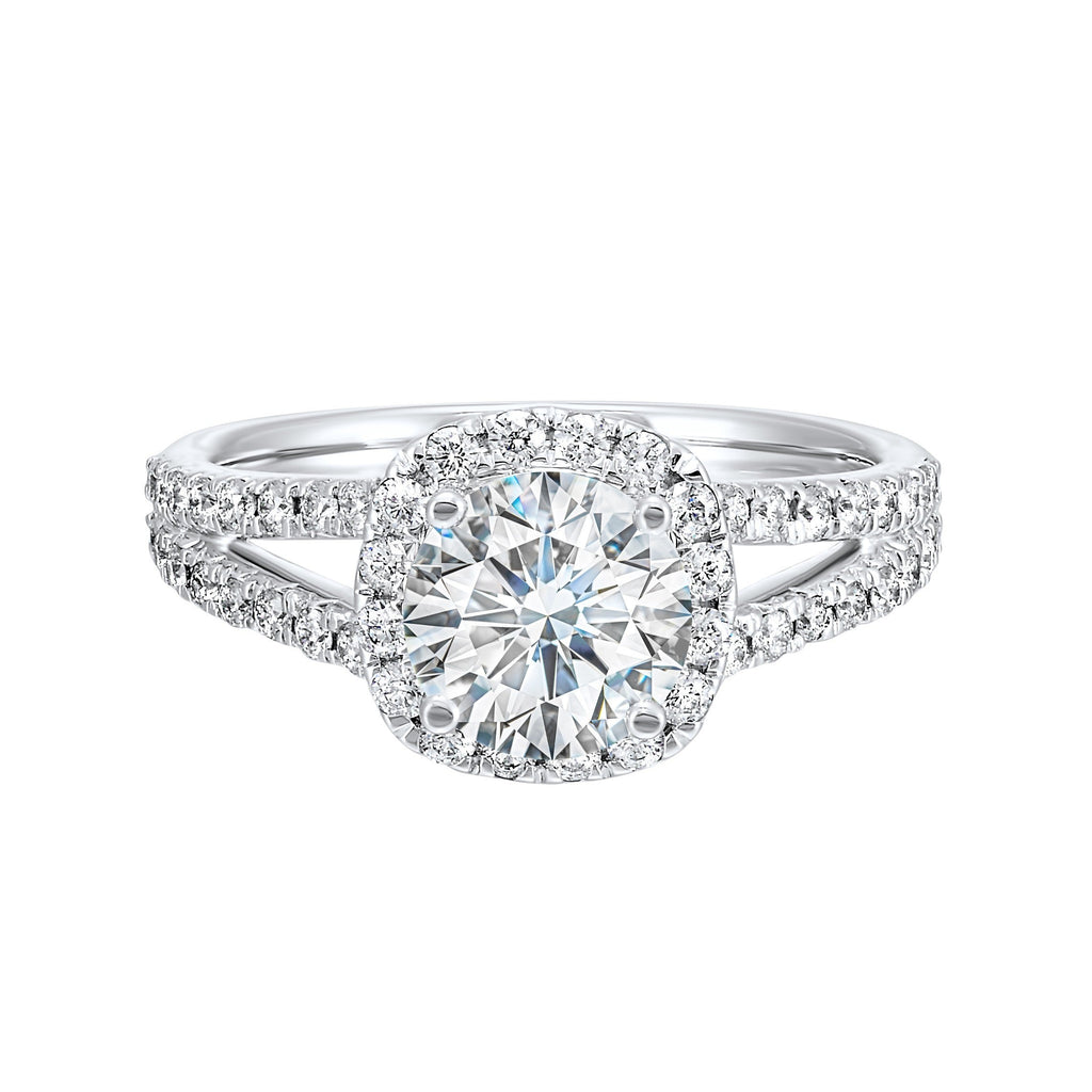 Cushion halo is a stunning way to showcase the round solitaire diamond. Modern split diamond studded shank further highlights the center.