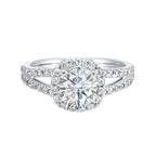Cushion halo is a stunning way to showcase the round solitaire diamond. Modern split diamond studded shank further highlights the center.