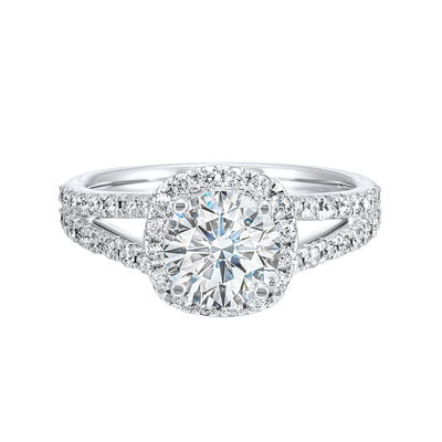 Cushion halo is a stunning way to showcase the round solitaire diamond. Modern split diamond studded shank further highlights the center.