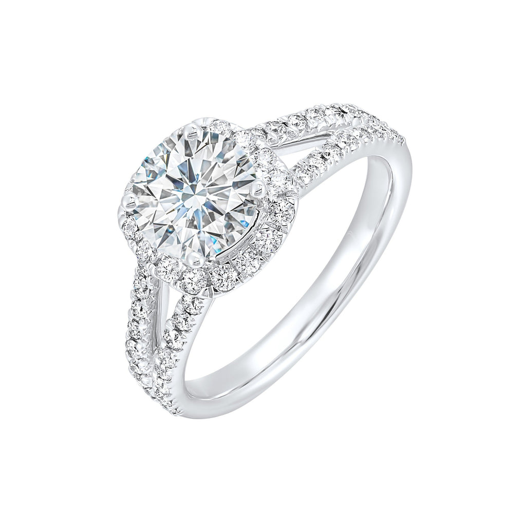 Cushion halo is a stunning way to showcase the round solitaire diamond. Modern split diamond studded shank further highlights the center.