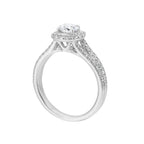 Cushion halo is a stunning way to showcase the round solitaire diamond. Modern split diamond studded shank further highlights the center.