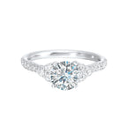 A trio of round diamonds on either side of the solitaire followed by a diamond studded shank, this ring is sure to impress her.
