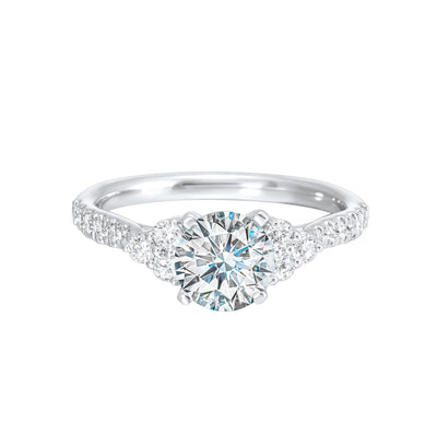 A trio of round diamonds on either side of the solitaire followed by a diamond studded shank, this ring is sure to impress her.