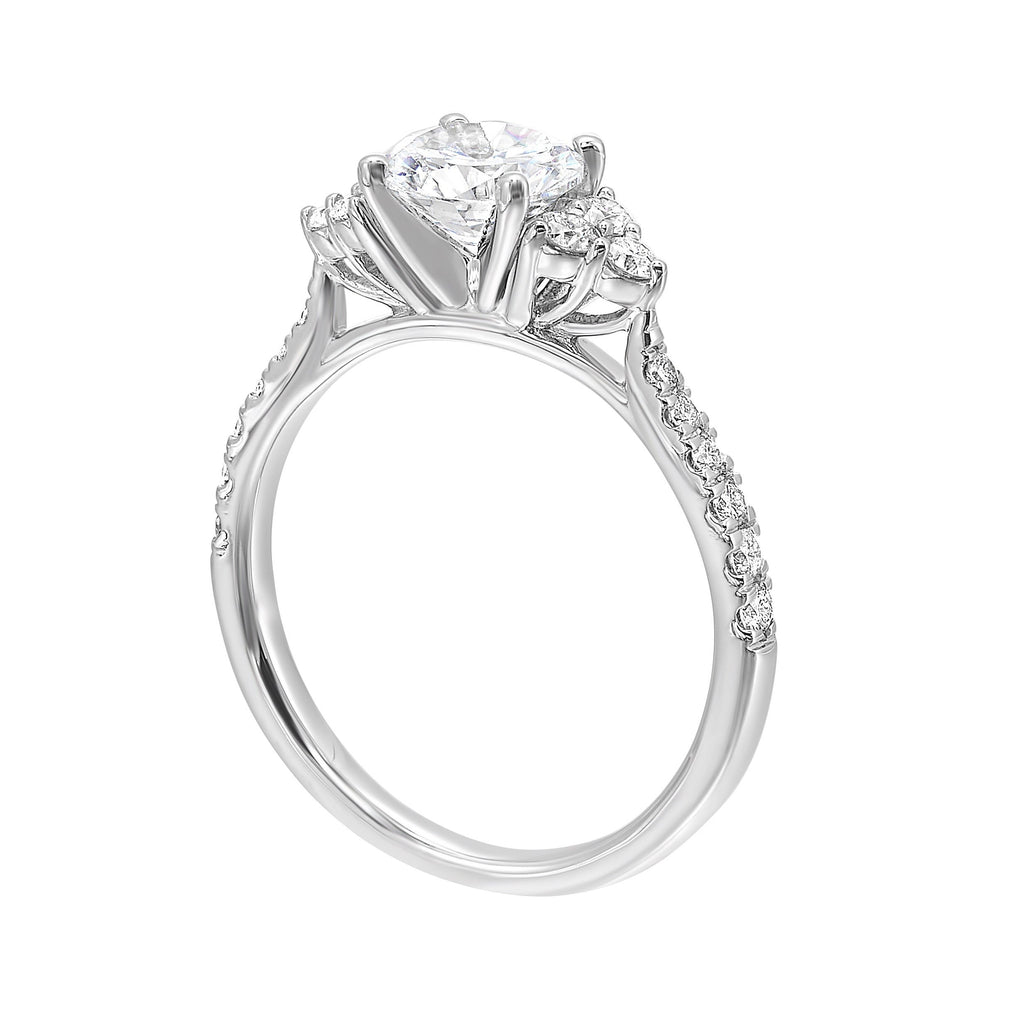 A trio of round diamonds on either side of the solitaire followed by a diamond studded shank, this ring is sure to impress her.