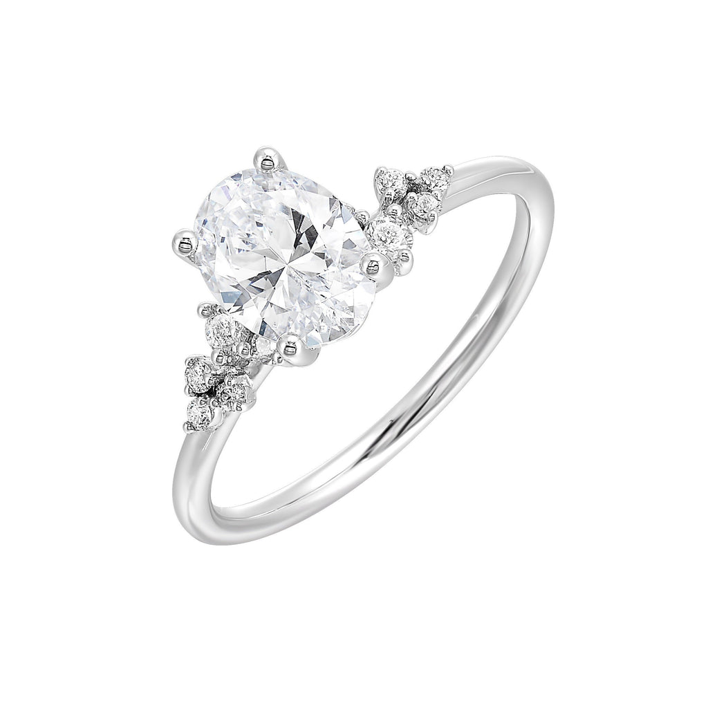 This simply gorgeous engagement ring with oval center features a sleek gold band with floating diamonds on either sides in random placement coming together beautifully.