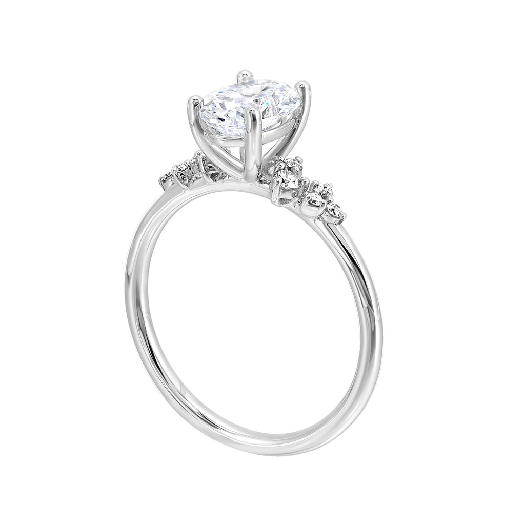 This simply gorgeous engagement ring with oval center features a sleek gold band with floating diamonds on either sides in random placement coming together beautifully.