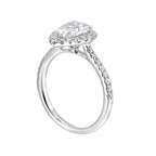 The pear cut solitare shines in this elegant ring, embraced by a delicate halo. The diamond shank adds a touch of sparkle, showcasing the beauty of the pear and halo at its finest.