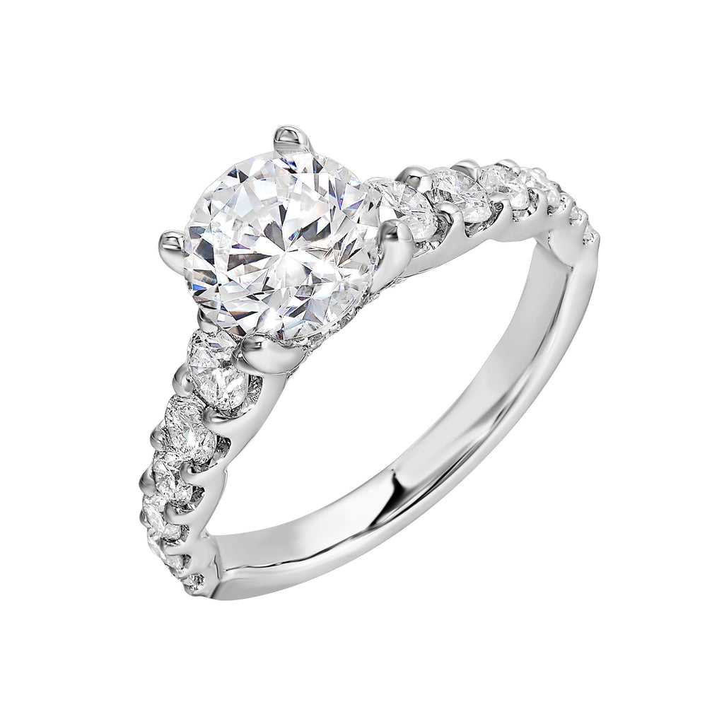 A classic round solitaire elevated by a graduating diamond shank set in common prong offers timeless elegance. Is perfect for your love story.