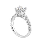A classic round solitaire elevated by a graduating diamond shank set in common prong offers timeless elegance. Is perfect for your love story.