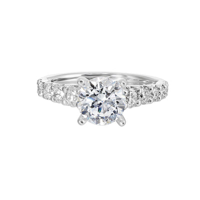 A classic round solitaire elevated by a graduating diamond shank set in common prong offers timeless elegance. Is perfect for your love story.