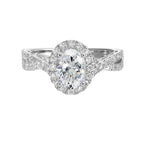 Shimmers of entwined shank with a classic halo and round center diamond is sure to delight you.