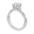 Stunning with a round solitaire diamond set in dual prongs atop a modern crisscross band. The unique twist on timeless elegance is perfect for the modern bride.